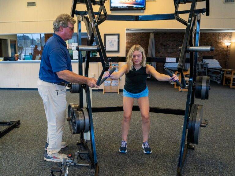 Patient working on upper body strength under therapist guidance